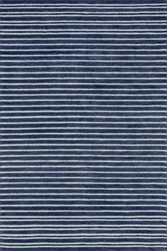 a blue and white rug with horizontal stripes