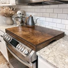 a stove top sitting in the middle of a kitchen