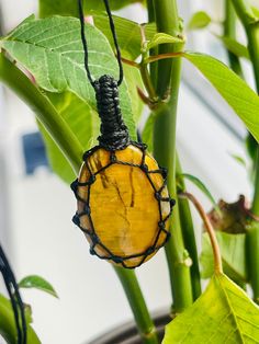 This handmade crystal necklace is featuring a drop shaped 2,5 cm wide and 3.5 cm high nellite amulet. The stone is fixed by the beautiful macrame technique in a thick, durable and resistant cotton cord. The necklace length  is adjustable. THE VIDEO IS TO SHOW THE WAY THE LENGTH CAN BE ADJUSTED ON THESE AMULETS. Nellite occurs when Tiger Eye and Pietersite meet and is thus a combination of both. The blue and golden minerals meet to form an extremely rare and unique appearance that glistens and shows it's true chatoyancy. Nellite is found in select mines in both South Africa and Namibia. Nellite awakens one's confidence and infuses your body with self-belief and appreciation for your accomplishments thus far. It is beautiful as a gift for both man and woman. Please note that the necklace is Handmade Amber Crystal Necklace For Meditation, Spiritual Yellow Crystal Necklace Gift, Handmade Oval Pendant Crystal Necklaces As Gifts, Handmade Oval Pendant Crystal Necklace As Gift, Handmade Oval Pendant Crystal Necklace For Gift, Handmade Teardrop Crystal Necklace For Healing, Yellow Crystal Necklaces For Gift, Handmade Oval Crystal Necklace Gift, Yellow Crystal Gemstone Bead Necklace For Gifts