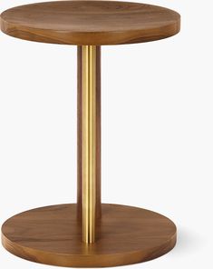 a round wooden table with gold metal legs