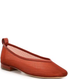 a woman's red ballet shoe with an open toe and bow on the side