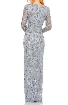 Lustrous sequins illuminate this glamorous gown designed with semisheer long sleeves. 61" length Jewel neck Long sleeves Lined 100% polyester Spot clean Imported Asian Owned/Founded Embellished Long Sleeve Cocktail Gown, Long Sleeve Embellished Cocktail Gown, Glamorous Long Sleeve Holiday Gown, Glamorous Long Sleeve Gown For Holidays, Festive Long Sleeve Sequin Gown, Embellished Long Sleeve Mother Of The Bride Evening Dress, Long Sleeve Sequin Gown For Formal Occasions, Formal Long Sleeve Gown With Sequins, Formal Long Sleeve Sequin Gown