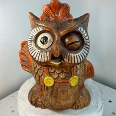 an owl figurine is sitting on top of a table