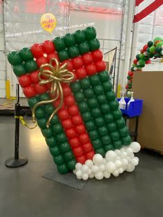 an inflatable christmas stocking is on display at the holiday fair, with balloons attached to it