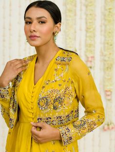 Editor's Note Mustard Hand Embroidered Jacket With Matching Peplum And Sharara In Crepe Fabric: Crepe, Organaza Color: Mustard Care: Dry Clean Only About the Designer Sanya Gulati's designs are inspired by the Indian bridesmaids, pastel easy hues & seasonal trends, her designs are a mix of modern, contemporary embroideries with traditional silhouettes thus creating our signature asymmetric checks embroideries amalgamated with floral thread work, through her designs, the designer aims to enhance Jacket With Sharara, Organza Jacket, Blouse Yoke, Indian Bridesmaids, Personal Shopping Service, Contemporary Embroidery, Sanya, Sharara Set, Feminine Beauty