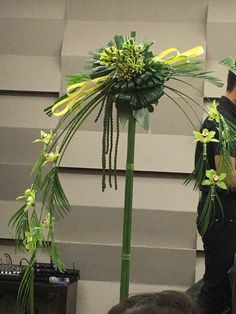 two men standing next to each other in front of a building with flowers on it