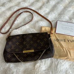 In Overall Good Used Condition. Normal Wear And Slight Imperfections On Hardware. Small Stain On Inside Of Bag Which Could Be Cleaned. Comes With Dust Bag And Note Of Authenticity From Poshmark. Can Be Worn As Crossbody, Small Gold Chain For Shoulder Bag Or Tuck It In And Carry As A Clutch. Luxury Brown Crossbody Wallet On Chain, Small Gold Chain, Louis Vuitton Wallet On Chain, Louis Vuitton Favorite, Brown Gold, Gold Chains, Louis Vuitton Bag, Dust Bag, Bag Lady