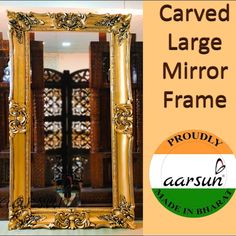 an ornate gold mirror frame with the words carved large mirror frame in front of it