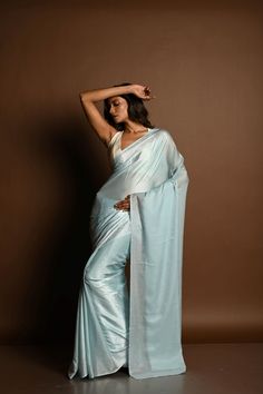 This stunning ice blue satin saree is adorned with elegant stonework, making it perfect for special occasions. Embrace timeless beauty with this luxurious piece. Blue Wedding Pre-draped Saree With Zari Weaving, Elegant Formal Pre-draped Saree With Zari Weaving, Elegant Formal Art Silk Pre-draped Saree, Elegant Blue Pre-draped Saree With Zari Weaving, Blue Tissue Silk Pre-draped Saree With Dupatta, Blue Tissue Silk Pre-draped Saree For Diwali, Blue Georgette Pre-draped Saree For Formal Occasions, Elegant Fitted Katan Silk Pre-draped Saree, Elegant Evening Traditional Wear In Tissue Silk