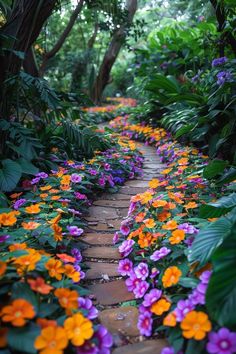 colorful flowers are growing on the side of a brick path in a tropical garden area