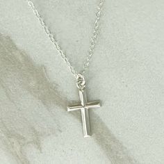 GRACE CROSS Necklace * Sterling Silver Cross Necklace * Dainty Cross Necklace* Delicate * Dainty *  Minimal * Silver Cross Necklace 14k Gold Filled GRACE Cross necklace in the last photo is sold in a separate listing:  https://www.etsy.com/listing/1737564118/grace-cross-necklace-14k-gold-filled LENGTH:  Available in:    14", 16", 18", 20" or 24"  - each comes with a 3" extender MATERIALS: Fine chain is Sterling Silver.  Clasp and connector rings are also Sterling Silver. Cross pendant is Sterling Silver and is 10x17mm.  See the photo with a ruler for size in inches.  The pendant is small and dainty. CARE:  Water and perfume are what cause most tarnishing - so the necklace needs to be stored in a dry place and not worn in the shower.  Limiting perfume in the neck area will also prolong the Necklace Simple Silver, Cross Necklace Simple, Dainty Cross Necklace, Silver Cross Necklace, Sterling Silver Cross Necklace, Sterling Silver Cross Pendant, Sterling Silver Cross, Necklace Dainty, Necklace Sterling Silver