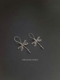 Beautiful silver dragonfly earrings with amethyst beads. Very detailed silver dragonflies are on handmade stainless steel ear hooks. Total earring length is just under 2 inches.  *Silver plated brass dragonflies  *Stainless steel ear hooks *Faceted amethyst beads  *Handmade with love <3 Like Jmesjewelrybox on Facebook for updates on new jewelry, upcoming sales and giveaways! Plus Facebook fans save 5% :D Find the coupon code on Jmesjewelrybox's cover photo https://www.facebook.com/Jmesjewelrybox Dainty Sterling Silver Dragonfly Jewelry, Dainty Silver Dragonfly Jewelry, Purple Metal Earrings As Gift, Purple Metal Earrings For Gift, Nickel-free Sterling Silver Dragonfly Jewelry, Handmade Silver Dragonfly Jewelry, Elegant Sterling Silver Dragonfly Jewelry, Elegant Hypoallergenic Dragonfly Earrings, Handmade Purple Metal Earrings