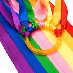 a close up of a rainbow colored ribbon with a ring on it's end