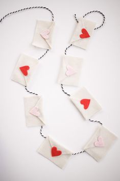 paper hearts are attached to string with twine