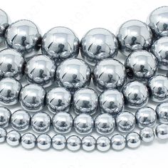 silver metallic round beads on white background