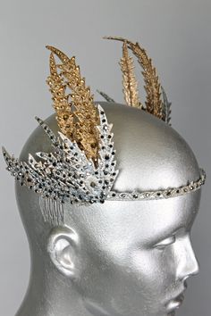 td {border: 1px solid #ccc;}br {mso-data-placement:same-cell;} This is a one of a kind piece of wearable art made for the Five and Diamond Eighth Annual Headgear Art Show and shown on June 12, 2020. Inspired by a classic 1930’s coronet from the House of Cartier. Designed by Kalico Delafey One of a kind Unisex MATERIALS USED Guipure lace milinery wire, mixed mediums, gold studded crystals, Swarovski crystals, combs and metal headband. WEARING INSTRUCTIONS Place at center on the front of the head Head Peice, Masquerade Ball Party, Headpiece Diy, Head Art, Crystals Swarovski, Diy Crown, Metal Headband, Tea Party Hats, Metal Headbands