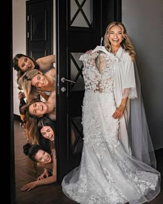 the bride is posing with her bridal party friends in front of an open door