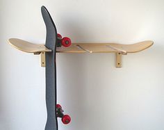 a skateboard mounted to the side of a wall with two wheels on each end