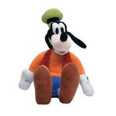 a mickey mouse stuffed animal sitting on top of a white floor with his legs crossed