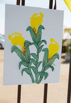 a white sign with yellow flowers on it