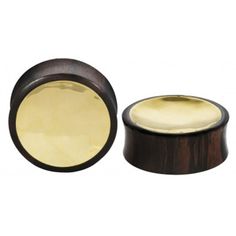 two wooden plugs with gold in the top and one on the bottom are shown