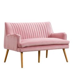 a pink velvet couch with wooden legs