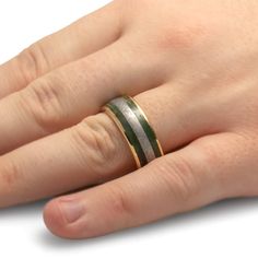 Gibeon meteorite's otherworldly pattern meets the dark tones of jade in this men's wedding band. Bringing a touch of brighter color, the edges of this meteorite ring are made of polished yellow gold. This unique, green wedding band is a perfect symbol of your endless love and marriage. RING LAYOUTRing Width: 10 mmRing Sleeve: 14k Yellow GoldRing Profile: RoundRing Finish: Polished 1 mm 14k Yellow Gold2.5 mm Green Jade3 mm Gibeon Meteorite2.5 mm Green Jade1 mm 14k Yellow Gold Green Wedding Band, Jade Wedding, Meteorite Wedding Band, Gibeon Meteorite, Meteorite Jewelry, Marriage Ring, Engraved Wedding Rings, Meteorite Ring, Yellow Gold Wedding Band