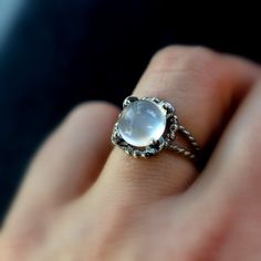 Glowing White Moonstone Cabochon Is prong set in my handcrafted Setting. The sterling is tarnish resistant, however I've intentionally tarnished this piece to add to the depth of the setting, and the higher parts are polished to a high shine. The overall width is approximately 14mm across the face of the ring and the stone is set nice and low, open in back. 925 Sterling Silver is Nickel free, Recycled AND Tarnish resistant. Pretty Objects, Moonstone Rings, Nature Inspired Engagement Ring, Amethyst Ring Engagement, Moonstone Cabochon, Split Shank Ring, Jotaro Kujo, Jewels Rings, White Moonstone