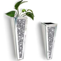 two silver vases with plants in them