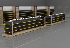 three empty shelves in a room with yellow and black trims on them, all lined up next to each other