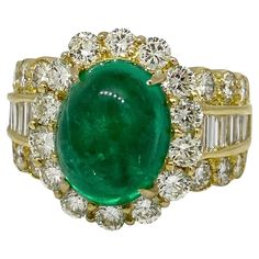 5.12 Carats Emerald Cabochon & Diamond Ring in 18k Yellow Gold Emerald Cabochon and Diamond Ring features one center Cabochon Emerald accented by Baguettes and Round Brilliant cut Diamonds set in 18k Yellow Gold. Total emerald weight is 5.12 carats. Total diamond weight is 2.33 carats. Ring size is 6.5 Ring weighs 13 grams. Ring dimensions are 0.65" by 0.85" and the ring rises 0.42" above the finger. Set in 18k Yellow Gold. Hallmarks: K18, E 5.12, D 0.44, 2.00 BUY WITH CONFIDENCE Authenticity is Colombian Emerald Ring, Yellow Gold Cocktail Ring, Statement Rings Diamond, Emerald Gem, Emerald Diamond Ring, Vintage Style Rings, Gold Cocktail Ring, Colombian Emeralds, Diamond Cocktail Rings