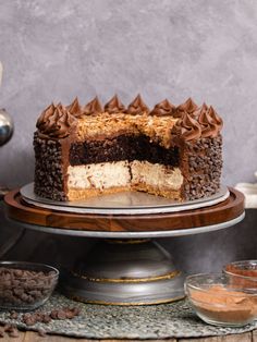 a cake with chocolate frosting and peanut butter on top is sitting on a platter