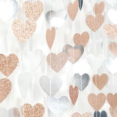 several hearts hanging from strings in different colors