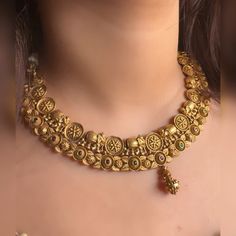 Very gorgeous and elegant matt gold jewellery embedded with reddish pink and green stones Includes necklace and earrings Goes perfectly with sarees and any formal or semi formal clothing. Perfect for wedding occasions. Premium quality and craftsmanship  Necklace length 14-16 inches with an adjustable golden dori at the back Each earring weighs 10 gms  Earrings: Pushback Dual-tone Kundan Temple Necklace For Wedding, Diwali Gold Lehenga With Intricate Design, Traditional Dual-tone Kundan Necklace For Wedding, Gold Dual-tone Kundan Necklace For Wedding, Dual-tone Temple Necklace Chandbali For Wedding, Brass Tilla Temple Necklace For Wedding, Dual-tone Temple Necklace For Wedding And Festive Occasions, Brass Temple Necklace With Tilla For Weddings, Festive Dual-tone Temple Necklace For Wedding