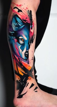 a woman's leg with colorful paint splattered on it and her face