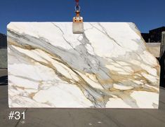 a large white marble slab sitting on top of a parking lot