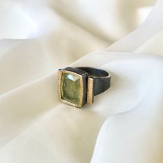 This 925 Sterling Silver one of a kind unique design ring is purely handmade, details are made of 24k gold and 9,15 ct natural faceted rare Yellowish Green Tourmaline is used as gemstone. The surface of the ring is oxidized (darkened) to create more rustic&authentic look.   This ring is suitable for the sizes between 8 US and 11 US. The dimensions of the ring is about 0.6 x 0.8 inches. Aquamarine: * stone of courage * brings the soothing and cleansing energy of the ocean * helps in emotional hea Modern Hand Forged Rings As A Gift, Unique Polished Emerald Ring As Gift, Hand Forged Modern Rings As Gifts, Unique Gold Emerald Ring In Sterling Silver, Modern Hand Forged Rings As Gift, Unique Gold Sapphire Ring In Sterling Silver, Yellow Gold Rings For Gifts, Unique Sterling Silver Emerald Ring With Gold Plating, Modern Gold Emerald Ring In Sterling Silver