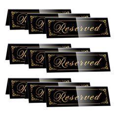 six black and gold reserved name tags