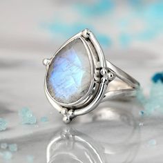 A stunning sterling silver ring with a genuine teardrop-shaped Moonstone gem. Wear this boho Moonstone ring and connect with the magic of the universe. Moonstone can symbolize the divine feminine, clarity, intuition and the moon phases.Material: Genuine Sterling Silver 92.5Gemstone: MoonstoneGemstone size: 15mmRing size: Choose your sizeLength/wide: 20mmCondition: Brand new Teardrop Moonstone Gemstone Ring, Bohemian Moonstone Ring With Moon Phase Detail, Bohemian Teardrop Gemstone Ring, Spiritual Teardrop Gemstone Rings, Spiritual Teardrop Moonstone Ring, Handmade Moonstone Teardrop Ring, Bohemian Moonstone Jewelry With Teardrop Shape, Bohemian Moonstone Teardrop Jewelry, Bohemian Teardrop Moonstone Ring Gift