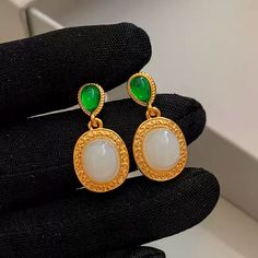 Expertly crafted with 24K gold-plated brass, these Elegant Hoop Earrings feature beautiful natural green and white chalcedony stones. The perfect mix of luxury and earthy beauty, each earring weighs only 1.86g, making them comfortable to wear. Add a touch of sophistication to any outfit with our Missy Jewelry Natural Stone Earrings Collection. Details Material: 24K gold-plated brass + Natural green chalcedony + Natural White chalcedony Color: Gold and green Size: Height 2.9cm, Width 1.25cm Weigh Elegant Green Onyx Gold Earrings, Gold Agate Gemstone Earrings, Gold Jade Gemstone Earrings, Elegant Green Agate Earrings, Green Agate Gemstone Earrings, Gold Chalcedony Dangle Earrings, Gold Jade Earrings, Handmade Gold Earrings With Chalcedony, Elegant Chalcedony Earrings With Natural Stones