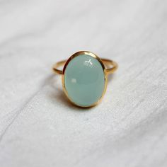 D E T A I L S - Material:  Sterling silver 925Stone:      Aqua ChalcedonyThe fit:     True to US ring size Finish:      Smooth and Gold Plated to a high shineS H I P P I N G & P R O D U C T I O N - My current production time is 2-6 business days, which means after those days are up, your order ships! I make everything custom to order, by hand, but I promise you it's worth the wait!R U S H - M Y - O R D E R -If you're in a rush to get your pretty new pieces, please send me a message and I'll Yellow Gold Chalcedony Ring Gift, Chalcedony Rings Fine Jewelry For Gift, Classic Chalcedony Ring Jewelry, Classic Chalcedony Rings As Gift, Oval Chalcedony Rings For Anniversary, Oval Chalcedony Rings Fine Jewelry, Anniversary Chalcedony Ring With Polished Finish, Handmade Chalcedony Rings For Anniversary, Elegant Chalcedony Rings For Gift