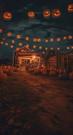 many pumpkins are lit up in front of a house at night with lights hanging from the roof