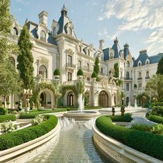 a large white mansion surrounded by trees and bushes