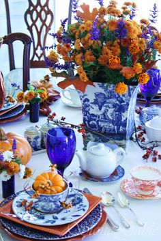 two pictures of the same table setting with pumpkins, flowers and other decorations on it