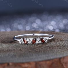 three stone ring on top of a piece of wood