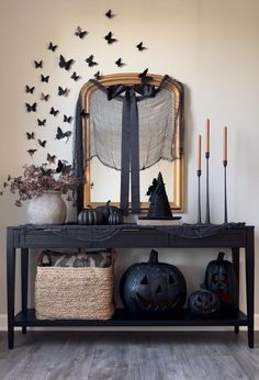 an entryway decorated for halloween with bats and pumpkins