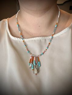 Handmade Summer Vibes Beaded Fringe Necklace. Coral, blue, white, and turquoise beads with a handmade Fringe Pendant. This necklace is so happy and vibrant! Clasp is handmade with 38mm antique copper plated ball pins. Necklace measures approximately 22 inches. Handcrafted items are just that, hand-made, some items may have variations in glass, stone, texture, or crimps. If you have any sizing concerns or questions, please message me ❤. Go Here for Jewelry Sizing Help! Bohemian White Necklaces With Dangling Beads, White Bohemian Necklaces With Dangling Beads, Bohemian White Beaded Necklaces With Dangling Beads, Bohemian White Necklace With Dangling Beads, White Bohemian Necklace With Dangling Beads, Handmade Dangle Beaded Necklaces For Beach, White Bohemian Beaded Shell Necklace, Bohemian White Shell Necklace With Beaded Chain, White Bohemian Shell Necklace With Beaded Chain