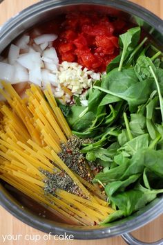 pasta, spinach and other ingredients in a pot