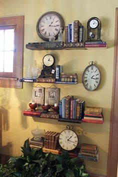 there are many books and clocks on the shelves in this room, all along with other things