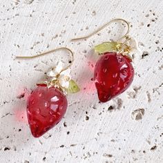 ♥ This exquisite earring features a stunning crystal texture that radiates beautiful light, adding a shimmering effect. The vibrant red strawberry design complements the delicate, translucent leaves, creating a captivating charm. The intricate details and glossy surface enhance the allure of these earrings. They are adored by garden enthusiasts and cherished by lovely young girls Length: 1.3 inches total (3.4cm) ♥ Care instructions: Substances like oil, nail polish, nail polish remover, chlorine Earrings Strawberry, Gold Fruit, Strawberry Flowers, Crystal Texture, Kawaii Strawberry, Strawberry Earrings, Strawberry Design, Strawberry Flower, Gift For Gardener